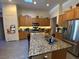 Kitchen with stainless steel appliances, granite counters, ample cabinet space and a convenient kitchen island at 5832 Elphin Ct, North Las Vegas, NV 89031