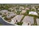 Aerial view of residential neighborhood showcases well-maintained homes and lush landscaping, with mature trees and community surroundings at 616 Canyon Brook Pl, Las Vegas, NV 89145
