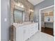 Bathroom showcasing double sinks with white marble countertops and a vanity space in the ensuite at 616 Canyon Brook Pl, Las Vegas, NV 89145