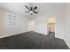 Bedroom features carpet floors, ceiling fan, ensuite access, and plantation shutters for privacy at 616 Canyon Brook Pl, Las Vegas, NV 89145