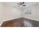 Bright bedroom featuring hardwood floors, ceiling fan, and large window with shutters at 616 Canyon Brook Pl, Las Vegas, NV 89145