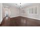 Bedroom featuring hardwood floors, shuttered windows, and a chandelier at 616 Canyon Brook Pl, Las Vegas, NV 89145