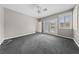 Large bedroom with neutral carpet, French doors, and shuttered windows at 616 Canyon Brook Pl, Las Vegas, NV 89145