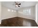 Bright bedroom showcasing wood flooring, ceiling fan, and plantation shutters on the windows at 616 Canyon Brook Pl, Las Vegas, NV 89145
