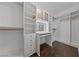 Walk-in closet features built-in shelves, drawers, vanity and makeup mirror for optimal organization at 616 Canyon Brook Pl, Las Vegas, NV 89145