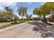 Gated community entrance with beautiful landscaping and mature trees at 616 Canyon Brook Pl, Las Vegas, NV 89145