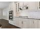 Gourmet kitchen with stainless steel appliances, marble countertops, and white cabinets at 616 Canyon Brook Pl, Las Vegas, NV 89145