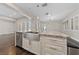 Kitchen island with double sink, marble counters, and stainless steel appliances at 616 Canyon Brook Pl, Las Vegas, NV 89145