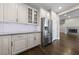 Modern kitchen with a stainless steel refrigerator, marble counters, and subway tile backsplash at 616 Canyon Brook Pl, Las Vegas, NV 89145