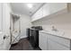 Laundry room featuring a washer and dryer, utility sink, and storage cabinets at 616 Canyon Brook Pl, Las Vegas, NV 89145