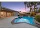 Inviting backyard pool and spa featuring lush landscaping and a covered patio, perfect for outdoor entertaining at 616 Canyon Brook Pl, Las Vegas, NV 89145