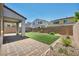 Private backyard with a covered patio, artificial grass, and well-maintained landscaping at 637 Our Heritage St, Henderson, NV 89011