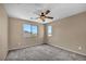 Bright carpeted bedroom features a ceiling fan and large windows for natural light at 637 Our Heritage St, Henderson, NV 89011