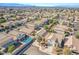 Aerial of neighborhood showcasing landscaped yards and home with pool and solar panels at 672 Peach Coral St, Las Vegas, NV 89183