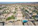 Expansive aerial view of a residential neighborhood, highlighting community layout and home with a backyard pool at 672 Peach Coral St, Las Vegas, NV 89183