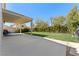 Large backyard with a covered patio, lush green lawn and privacy landscaping at 672 Peach Coral St, Las Vegas, NV 89183