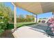 Backyard featuring a covered patio, seating area, and well-maintained lawn at 672 Peach Coral St, Las Vegas, NV 89183