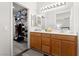 Bathroom with double sink vanity, large mirror, and walk-in closet at 672 Peach Coral St, Las Vegas, NV 89183