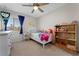 Cozy bedroom with a ceiling fan, window with natural light, and charming decor at 672 Peach Coral St, Las Vegas, NV 89183