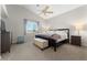 Bedroom with ceiling fan, large bed, neutral walls, and carpeted floor at 672 Peach Coral St, Las Vegas, NV 89183