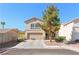 Charming two-story home with a well-manicured front yard and attached two-car garage at 672 Peach Coral St, Las Vegas, NV 89183