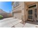 View of the front entrance with a two-car garage and landscaped front yard at 672 Peach Coral St, Las Vegas, NV 89183