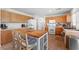 Well-lit kitchen featuring tile floors, center island, stainless steel appliances, and wood cabinets at 672 Peach Coral St, Las Vegas, NV 89183
