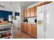 Well-lit kitchen with wooden cabinets, white appliances, and tile flooring at 672 Peach Coral St, Las Vegas, NV 89183