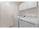 Clean laundry room with a modern washer and dryer, with white cabinets above at 672 Peach Coral St, Las Vegas, NV 89183