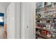 Pantry with wire shelves stocked with food items, adjacent to kitchen and refrigerator at 672 Peach Coral St, Las Vegas, NV 89183