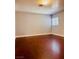 Simple bedroom with laminate flooring, neutral paint, and a window at 6786 Grandola Dr, Las Vegas, NV 89103