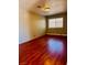 Neutral bedroom featuring laminate flooring, a window, and overhead lighting at 6786 Grandola Dr, Las Vegas, NV 89103