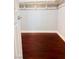 Empty walk-in closet with laminate flooring, open shelving, and white trim at 6786 Grandola Dr, Las Vegas, NV 89103