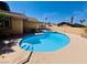 Backyard view of a refreshing in-ground pool with a tanning deck and patio furniture at 6786 Grandola Dr, Las Vegas, NV 89103