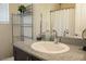 Well-lit bathroom featuring an oval sink with brushed nickel faucet, shelving unit and neutral paint at 6824 Satin Silver Ct, North Las Vegas, NV 89086