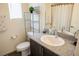Bright bathroom with granite countertop, modern fixtures, and decorative shelving at 6824 Satin Silver Ct, North Las Vegas, NV 89086