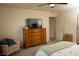 Cozy bedroom featuring a wooden dresser and flatscreen television for comfortable living at 6824 Satin Silver Ct, North Las Vegas, NV 89086