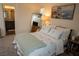 Inviting bedroom with a large mirror, artwork, and a comfortable bed with ample pillows at 6824 Satin Silver Ct, North Las Vegas, NV 89086