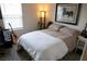 Comfortable bedroom with a guitar, side tables, and natural light from the window at 6824 Satin Silver Ct, North Las Vegas, NV 89086