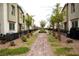 Exterior view of the townhome community featuring mature landscaping and inviting walkways at 6824 Satin Silver Ct, North Las Vegas, NV 89086