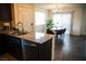Stainless appliances accent the granite counters of this stunning kitchen with dining area at 6824 Satin Silver Ct, North Las Vegas, NV 89086