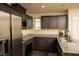 A lovely kitchen featuring stainless steel appliances, granite counters, and plenty of dark wood cabinet space at 6824 Satin Silver Ct, North Las Vegas, NV 89086