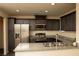 Modern kitchen featuring stainless steel appliances, granite counters, and dark wood cabinets at 6824 Satin Silver Ct, North Las Vegas, NV 89086