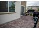 Cozy outdoor patio with pavers, comfortable seating, and private black metal fencing at 6824 Satin Silver Ct, North Las Vegas, NV 89086