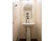 Modern powder room featuring pedestal sink, stylish mirror and neutral colors at 6824 Satin Silver Ct, North Las Vegas, NV 89086
