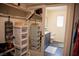 Walk-in closet leads to a bright bathroom, offering convenience and organization at 6824 Satin Silver Ct, North Las Vegas, NV 89086