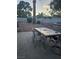 Backyard patio area with stone barbecue and dining table with chairs at 7104 Carrondale Way, Las Vegas, NV 89128