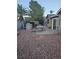 Backyard featuring stone barbecue and dining table, gravel landscaping at 7104 Carrondale Way, Las Vegas, NV 89128