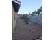 Side yard of home with rock landscaping, small trees and block wall at 7104 Carrondale Way, Las Vegas, NV 89128