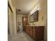 Bathroom featuring wood cabinets, a large vanity, and a sliding glass shower door at 7104 Carrondale Way, Las Vegas, NV 89128